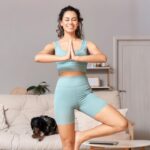 Sporty,Young,African-american,Woman,With,Cocker,Spaniel,Doing,Yoga,At