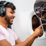 Passengers on Airplane Watching Inflight Entertainment