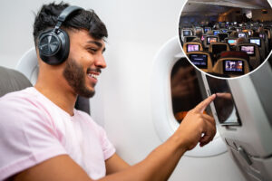 Passengers on Airplane Watching Inflight Entertainment