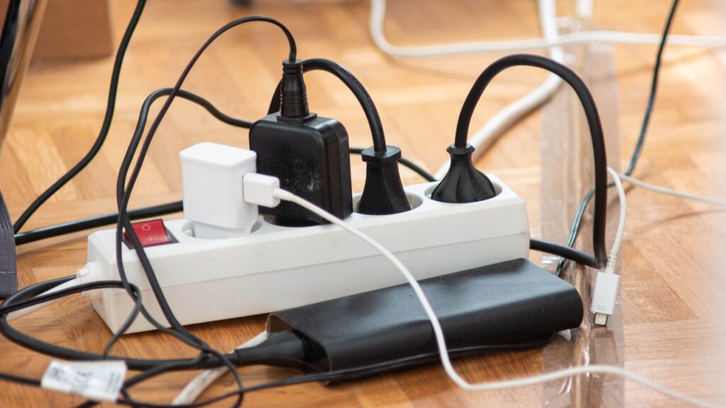 Messy,Outlet,Power,Extension,Cord,On,An,Apartment,Floor,With