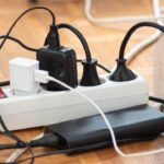 Messy,Outlet,Power,Extension,Cord,On,An,Apartment,Floor,With