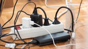 Messy,Outlet,Power,Extension,Cord,On,An,Apartment,Floor,With