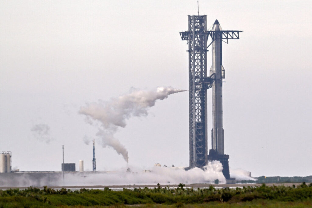 A SpaceX Super Heavy booster carrying the Starship spacecraft vents before the launch is scrubbed