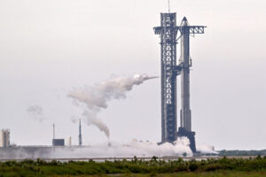 A SpaceX Super Heavy booster carrying the Starship spacecraft vents before the launch is scrubbed
