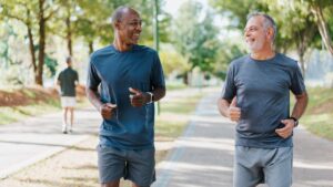 Two male friends running in the public park