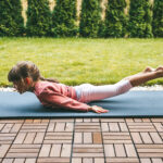 Little,Girl,5-6,Years,Old,Lying,In,A,Locust,Pose,