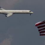 A Delta Airlines commercial aircraft flies over Washington as it approaches to land at Dulles International Airport