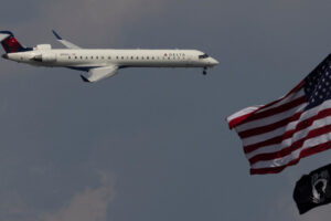 A Delta Airlines commercial aircraft flies over Washington as it approaches to land at Dulles International Airport