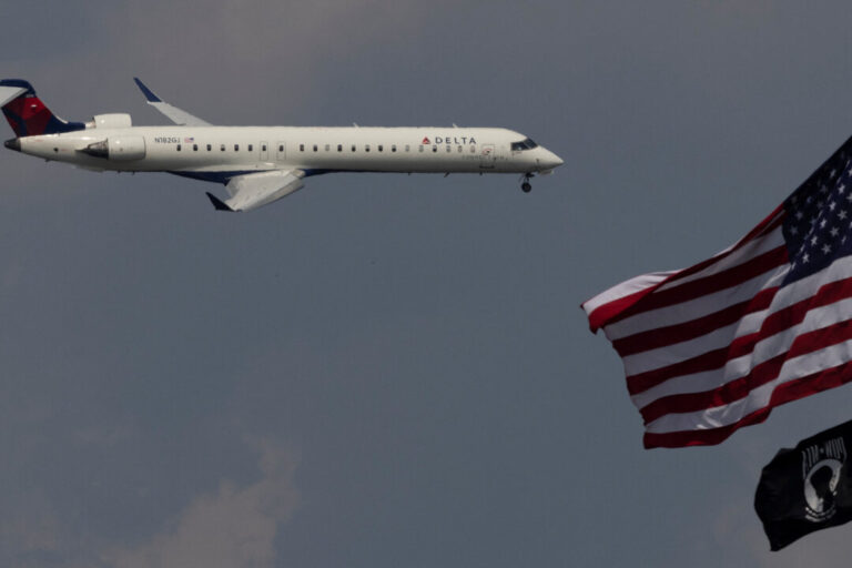 A Delta Airlines commercial aircraft flies over Washington as it approaches to land at Dulles International Airport
