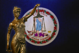 Lady Justice before a Virginia state flag