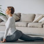 Young,Woman,Practising,Yoga,At,Home,On,Mat