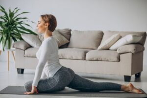 Young,Woman,Practising,Yoga,At,Home,On,Mat