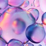 Multicolored chemical 3D molecules, bubbles, drops on blue, purple background.