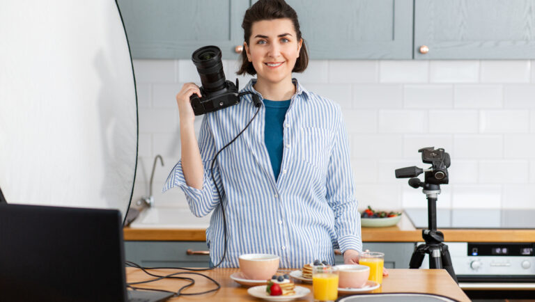 food photographer with camera working in kitchen